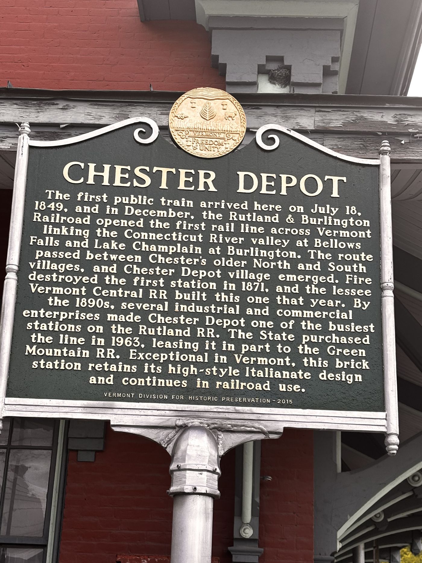 The Vermont historic marker at Chester Depot, recounting the first train on July 18, 1849, the 1871 station, the busy 1890s, and the State's 1963 purchase of the line.