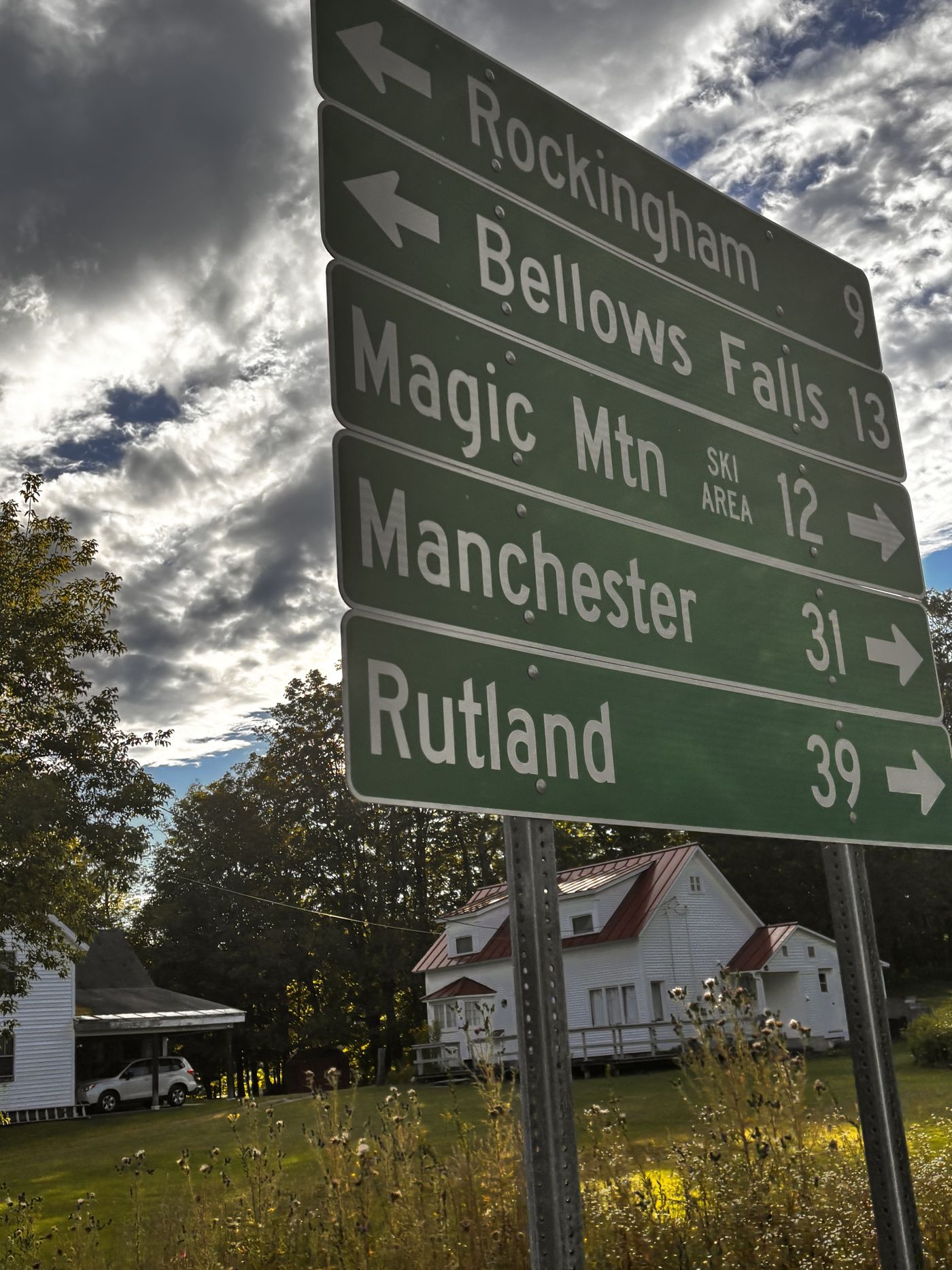 A green highway sign in Chester: Rockingham 9 and Bellows Falls 13 to the left; Magic Mountain ski area 12, Manchester 31 and Rutland 39 to the right.